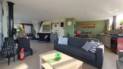 a living room with a couch and a kitchen at Drop of Heaven in Katokhórion