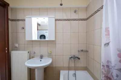 a bathroom with a sink and a bath tub at City Apartment with heated rooftop Pool in Chania Town
