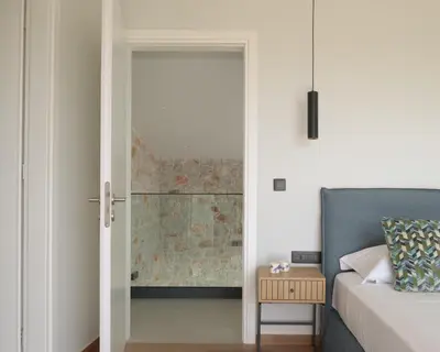 a bedroom with a door open to a bedroom with a bed at Blue Zone Villa, a SeaView Sanctuary with Pool, By ThinkVilla in Chania Town