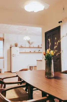 a vase of flowers sitting on a wooden table at The Yard Residence in Gavalochori