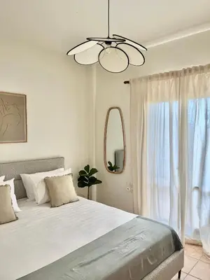 a bedroom with a large bed and a window at The Yard Residence in Gavalochori