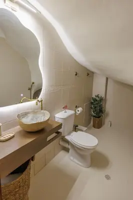 a bathroom with a white toilet and a sink at The Yard Residence in Gavalochori