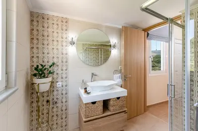 a bathroom with a sink and a mirror at Villa Noelia in Rogdhiá