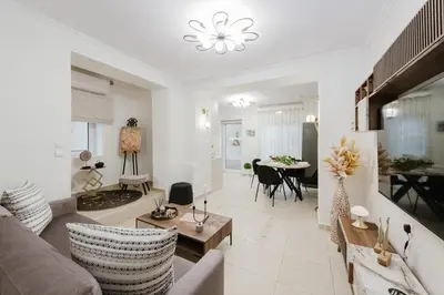 a living room with a couch and a table at Villa Noelia in Rogdhiá