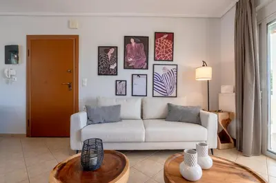a living room with a couch and a table at Koralia's Villas in Chorafakia