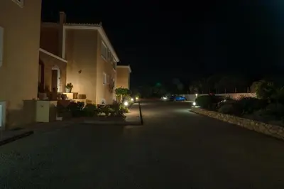 a night view of a house and a driveway at Koralia's Villas in Chorafakia