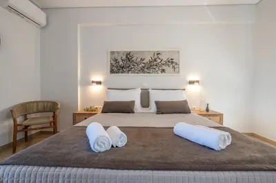 a bedroom with a large bed with two pillows at Koralia's Villas in Chorafakia
