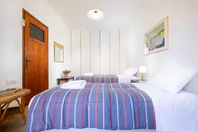 a hotel room with two beds and a table at Eleni Residences in Kalyves