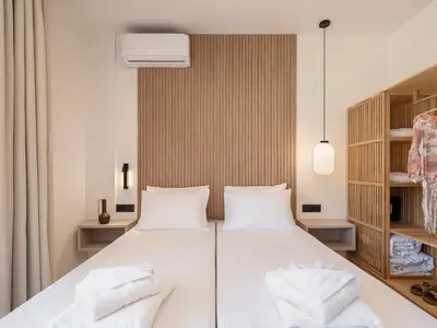 a bedroom with a large white bed with white pillows at Seaview villa with pool in nature next to Platanias in Plataniás