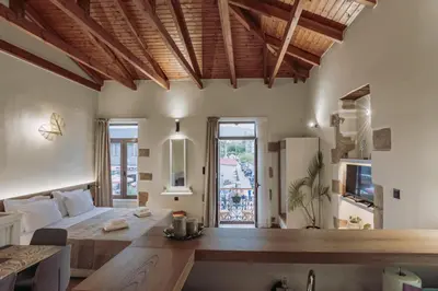a large bedroom with a large bed and a window at Santa Lucia - Cozy City Studio in Central Chania in Chania Town