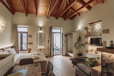 a living room with a couch and a table at Santa Lucia - Cozy City Studio in Central Chania in Chania Town