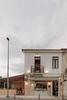 a white building with a balcony on top of it at Santa Lucia - Cozy City Studio in Central Chania in Chania Town