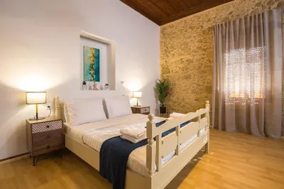 a bedroom with a large bed in a room at Manolis Stone House Villa in Mouríon