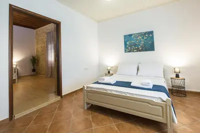 a bedroom with a bed in a room at Manolis Stone House Villa in Mouríon