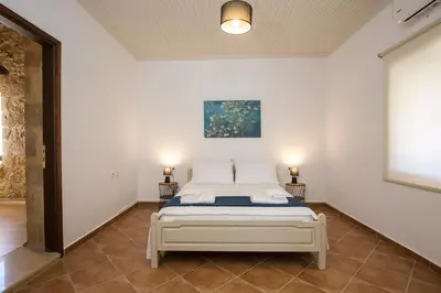 a bedroom with a bed in a room at Manolis Stone House Villa in Mouríon