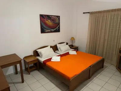 a bedroom with a bed with two towels on it at Michalis Studios & Aparntments in Palaiochóra