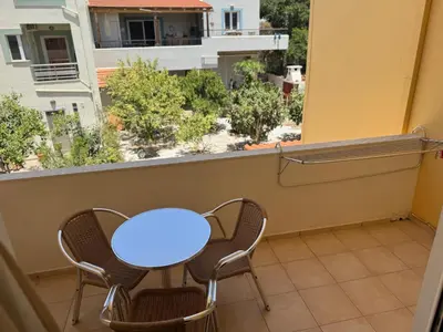 a table and chairs on a balcony with a view at Michalis Studios & Aparntments in Palaiochóra