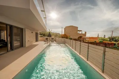 a swimming pool in the middle of a house at Villa Icons in Agia Marina Nea Kydonias
