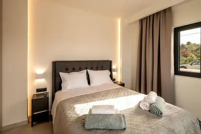 a bedroom with a large bed and a window at Villa Icons in Agia Marina Nea Kydonias