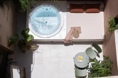 an overhead view of a bath tub in a room with plants at Qualia Slowlife Suites in Chania Town