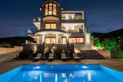 a house with a swimming pool in front of it at Naruto Villas in Kissamos