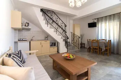 a living room with a couch and a table at Harbour Studios And Apartments in Palaiochóra
