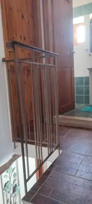 a metal railing in a room with a door at Charmante maison crétoise à Embrosneros in Embrósneros