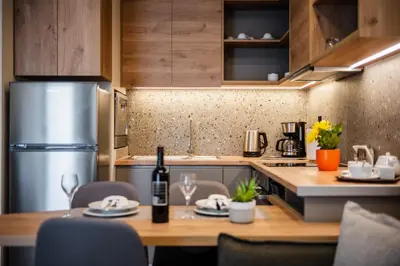 a kitchen with a table with a bottle of wine at Clio - Newly renovated Home with Parking in Chania Town