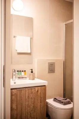 a bathroom with a sink and a toilet at Clio - Newly renovated Home with Parking in Chania Town