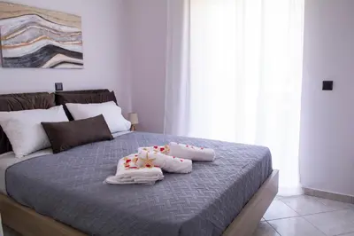 a bedroom with a bed with two towels on it at Benessere in Chania Town
