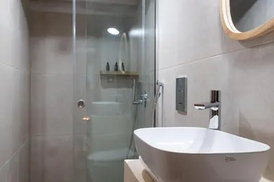 a bathroom with a sink and a shower and a tub at Delta-Rho in Kalami