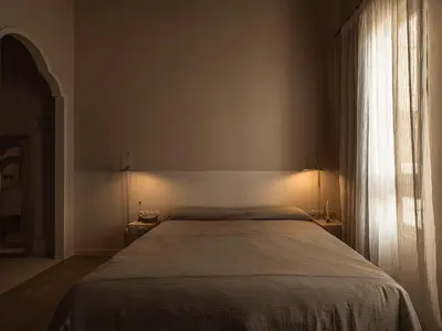 a bedroom with a large bed and a window at Aisha Hotel in Chania Town