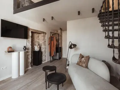 a living room with a couch and a tv at Aisha Hotel in Chania Town