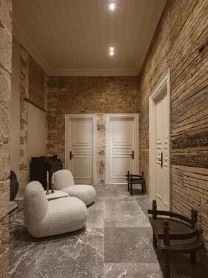 a living room with two chairs and a table at Aisha Hotel in Chania Town