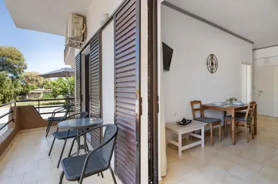 a balcony with chairs and a table and a table and chairs at Seafront Apartment in Chania 7 in Chania Town