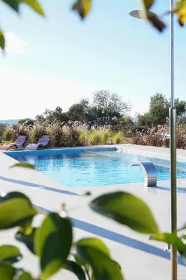 a swimming pool with lounge chairs in a resort at Afea Villas in Plataniás