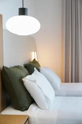 a bedroom with a bed with pillows and a light at Afea Villas in Plataniás