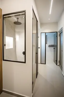 a hallway with a glass door and a walk in shower at Iria Sea View Room in Kolymvari