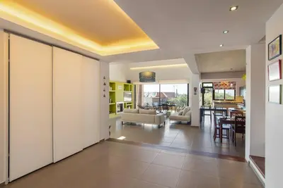 a living room with a couch and a dining room at Dream's House - Villa with Pool & Stunning Views in Daratso