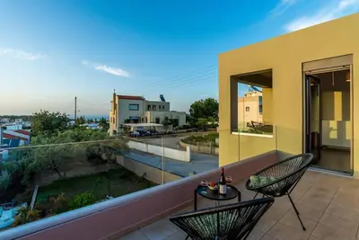 a balcony with two chairs and a view of a street at Dream's House - Villa with Pool & Stunning Views in Daratso