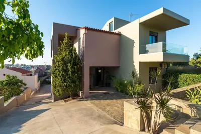 a white house with a tree in front of it at Dream's House - Villa with Pool & Stunning Views in Daratso