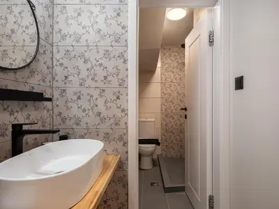 a bathroom with a tub and a toilet at Steki Luxury Room 1 in Chania Town