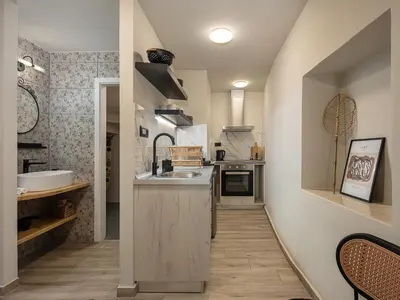 a small kitchen with a sink and a counter at Steki Luxury Room 1 in Chania Town