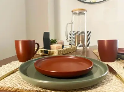 a bowl on a plate on a table with two cups at Steki Luxury Room 1 in Chania Town