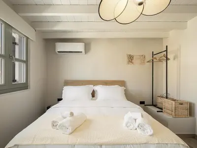 a bedroom with a bed with towels on it at Steki Luxury Room 3 in Chania Town
