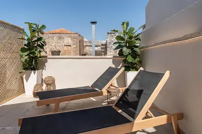 a pair of chairs sitting on a balcony at Steki Luxury Room 3 in Chania Town