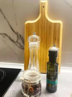 a bottle of oil next to a jar of olives at Steki Luxury Room 3 in Chania Town
