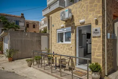 a building with a door and a balcony at Petra's Charming Home, 500m to Beach in Chania Town