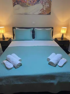 a bed with towels and pillows on top of it at Eolia apartment in Chania with Sea&City View in Chania Town