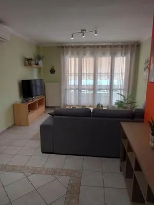 a living room with a couch and a television at Eolia apartment in Chania with Sea&City View in Chania Town